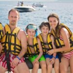 A family with children enjoys a day out on the water