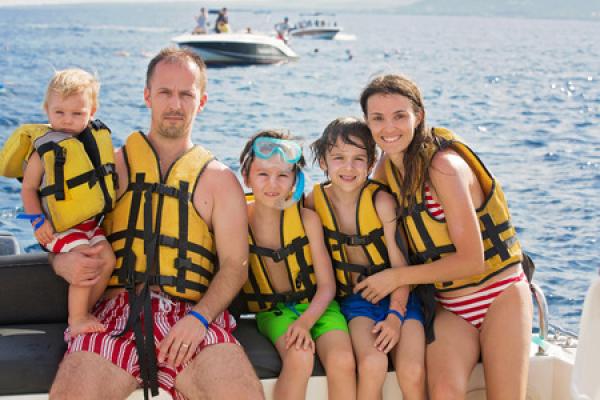A family with children enjoys a day out on the water