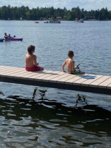 Photo 73 Two boys fishing off the side of a V-Dock